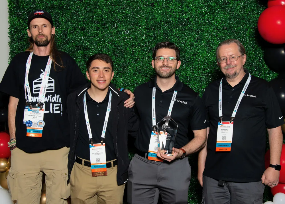 JackRabbit and LibreQoS team members holding the 2025 WISPA Product of the Year award